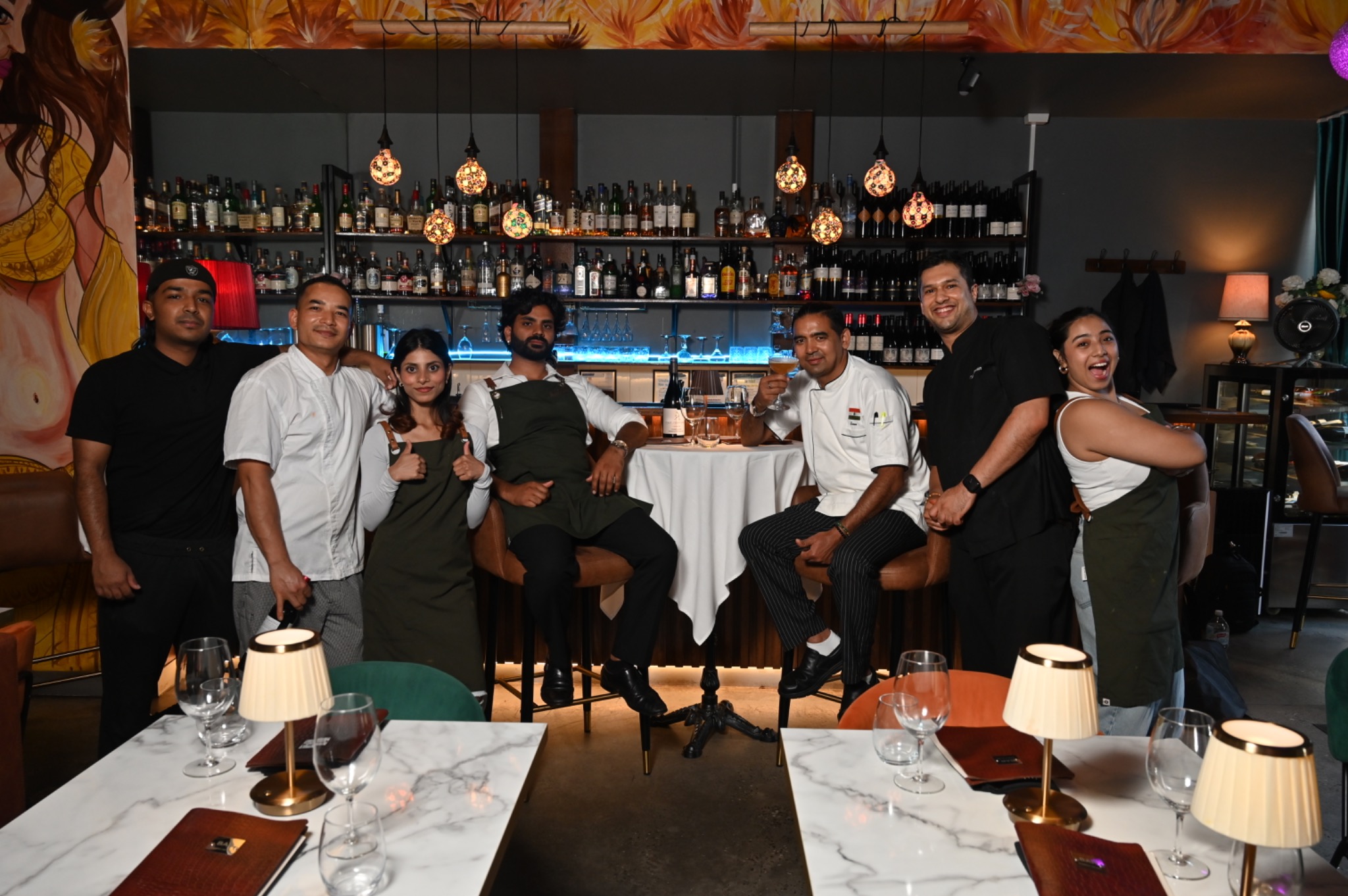 The Bombay on Bay team together in front of the restaurant bar
